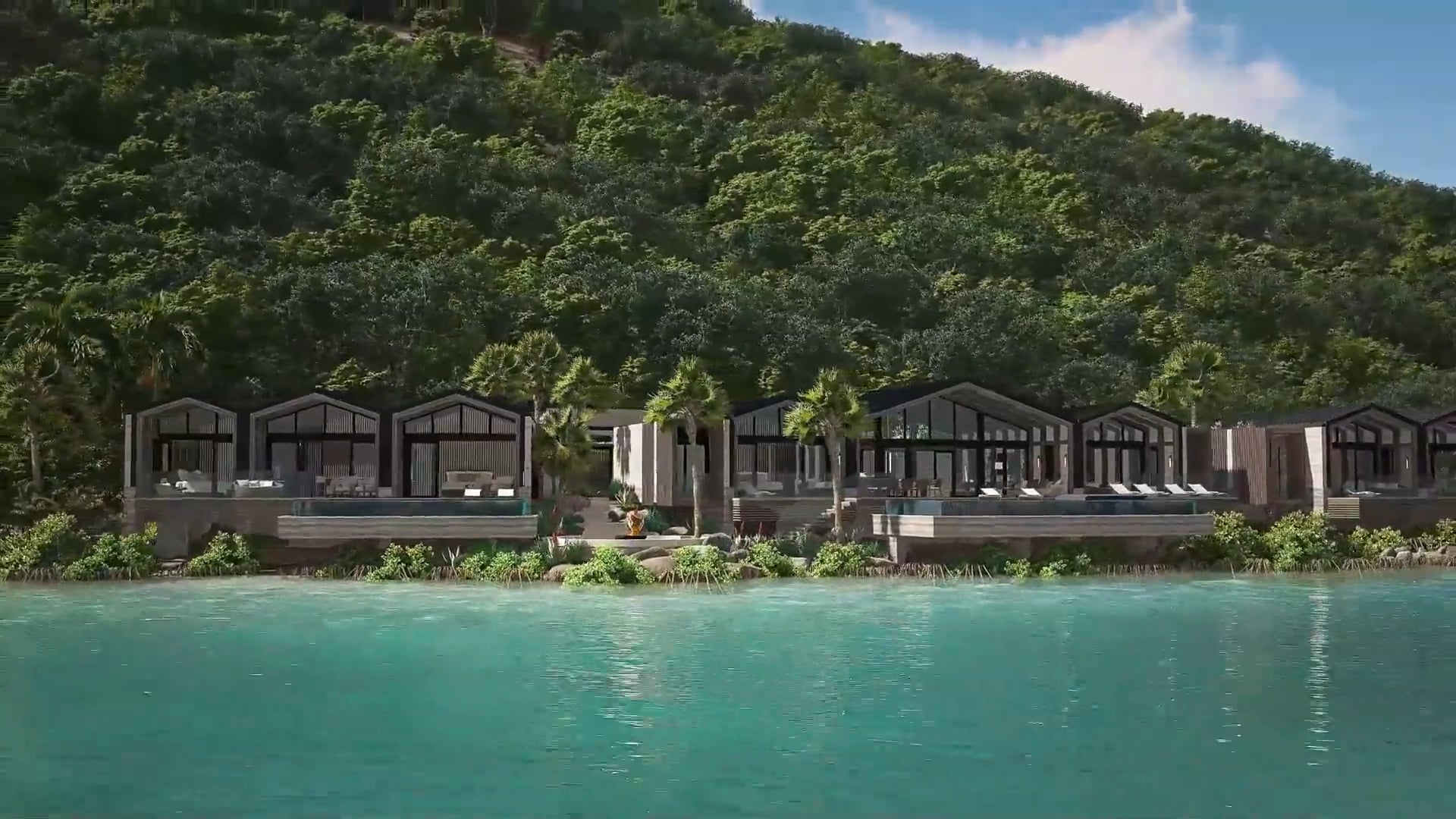 Modern beachfront villas with large windows and palm trees sit by a clear turquoise sea, reminiscent of a Casino Royale scene, nestled against a lush, green hillside under a blue sky.