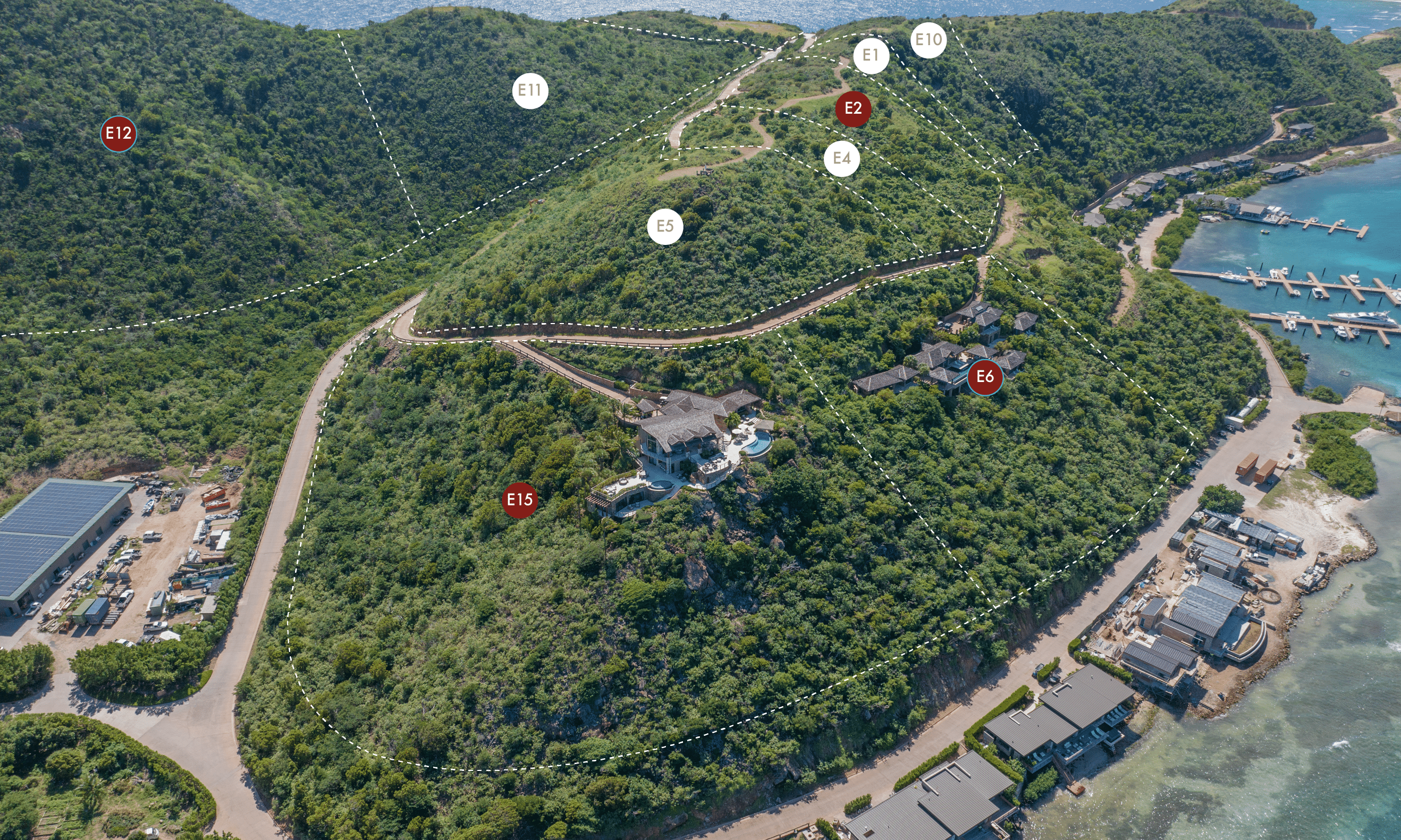 Aerial view of a hilly landscape featuring various plots of land marked with labels such as "E2," "E4," and "E15." A dividing line indicates the boundaries of each plot. Surrounding the hill is a marina, buildings, roads, and the Reef House offering scenic views.