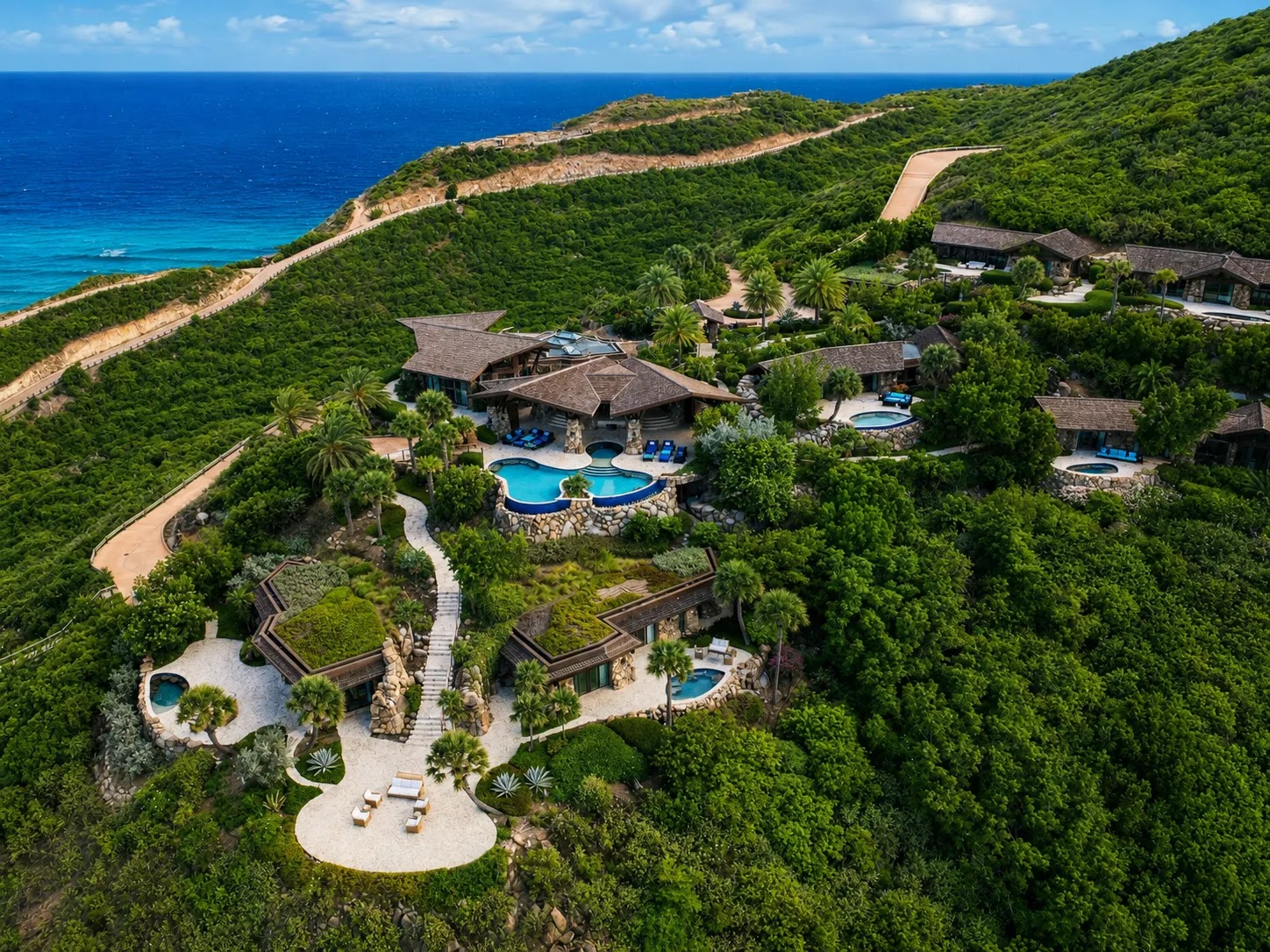 Private cliffside infinity pool and lounge terrace with expansive ocean views at Oil Nut Bay.