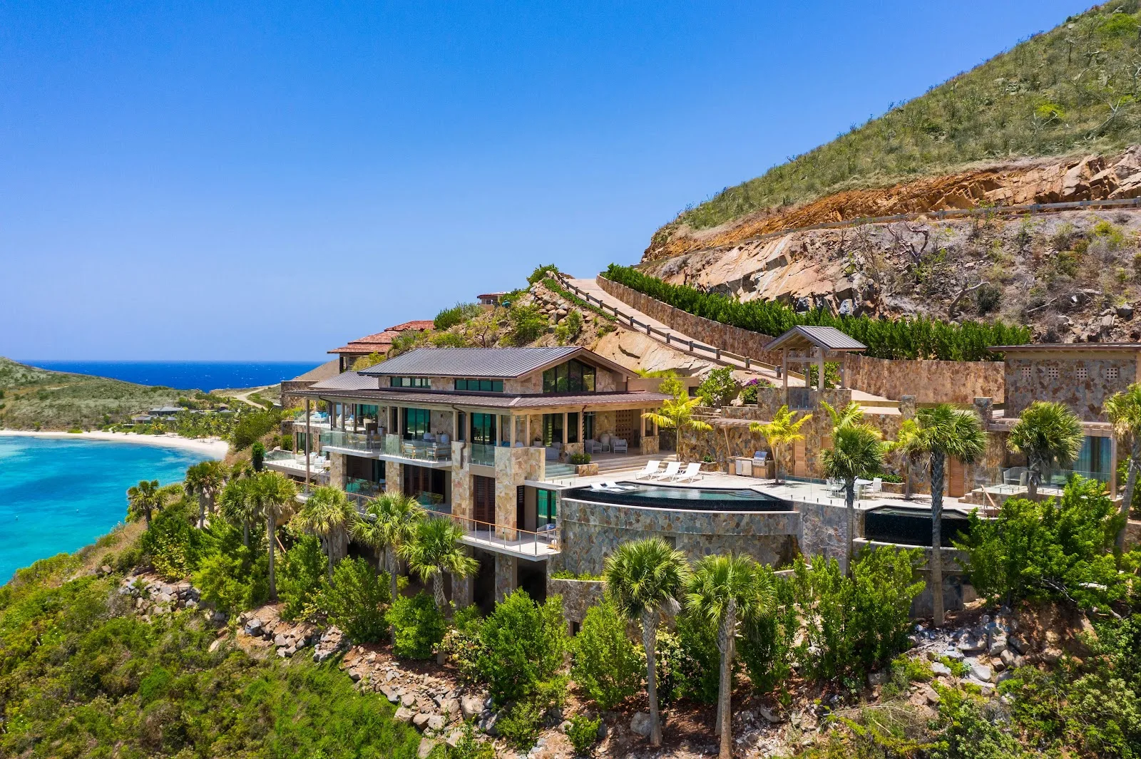 Aerial view of Villa Maronti set dramatically along the Virgin Gorda coastline above turquoise waters.