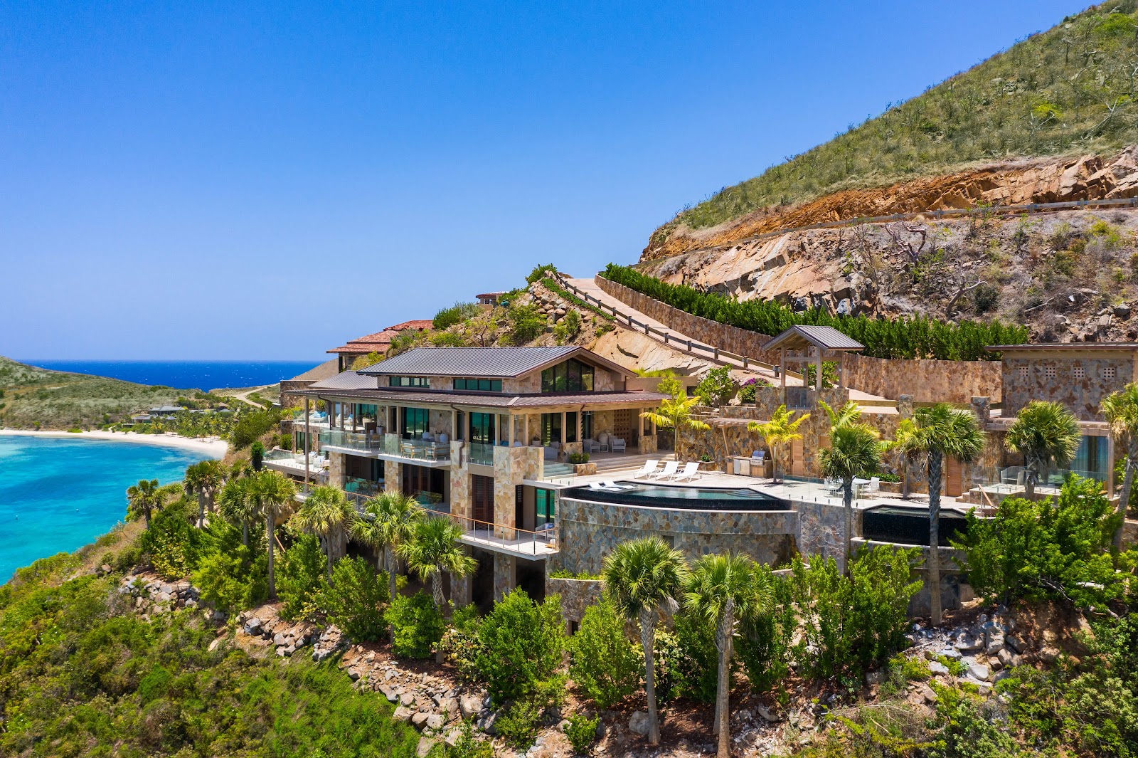 Aerial view of Villa Maronti set dramatically along the Virgin Gorda coastline above turquoise waters.