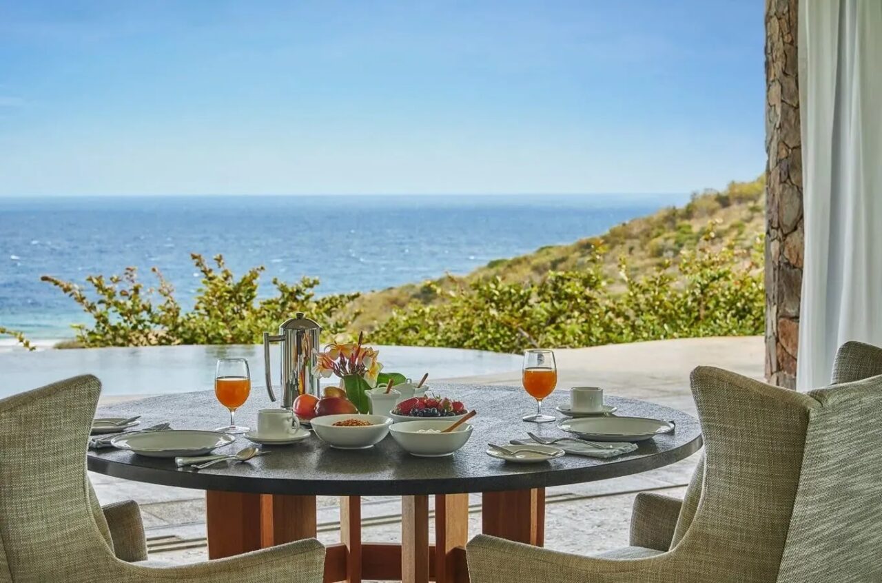 Breakfast served on an ocean-view terrace overlooking the sea at Oil Nut Bay, Virgin Gorda.