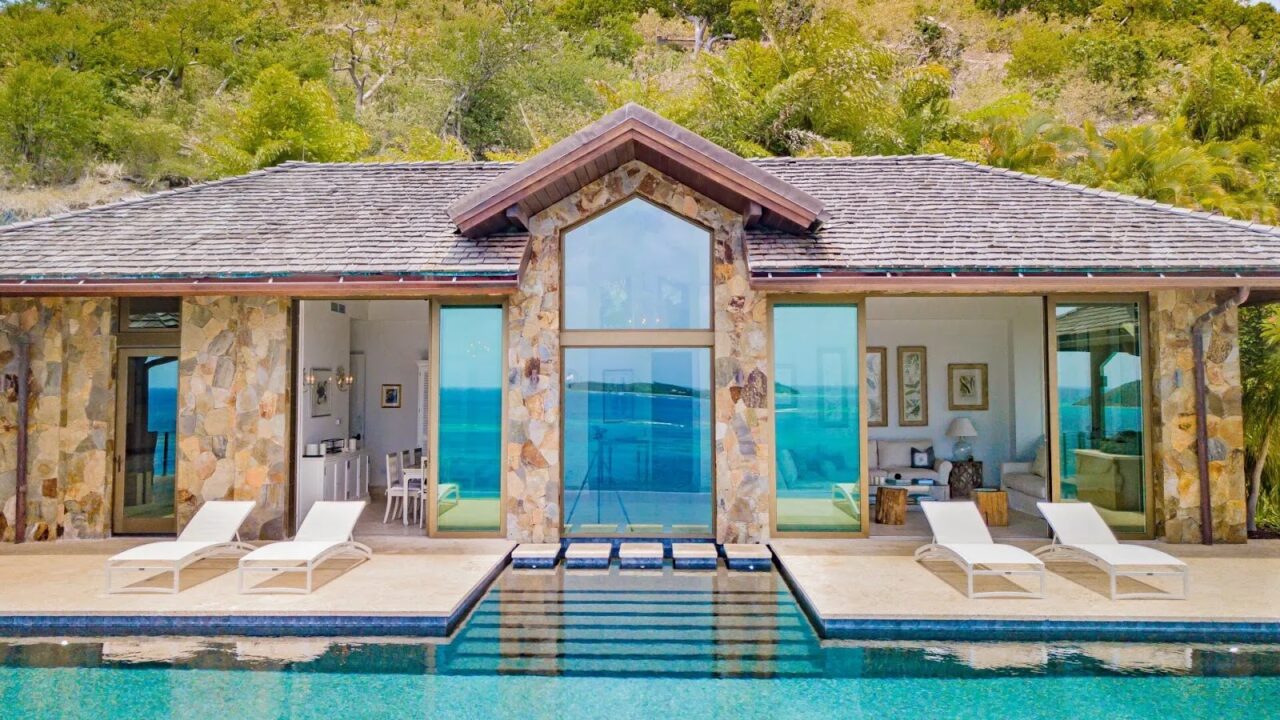 Private cliffside infinity pool and lounge terrace with expansive ocean views at Oil Nut Bay.