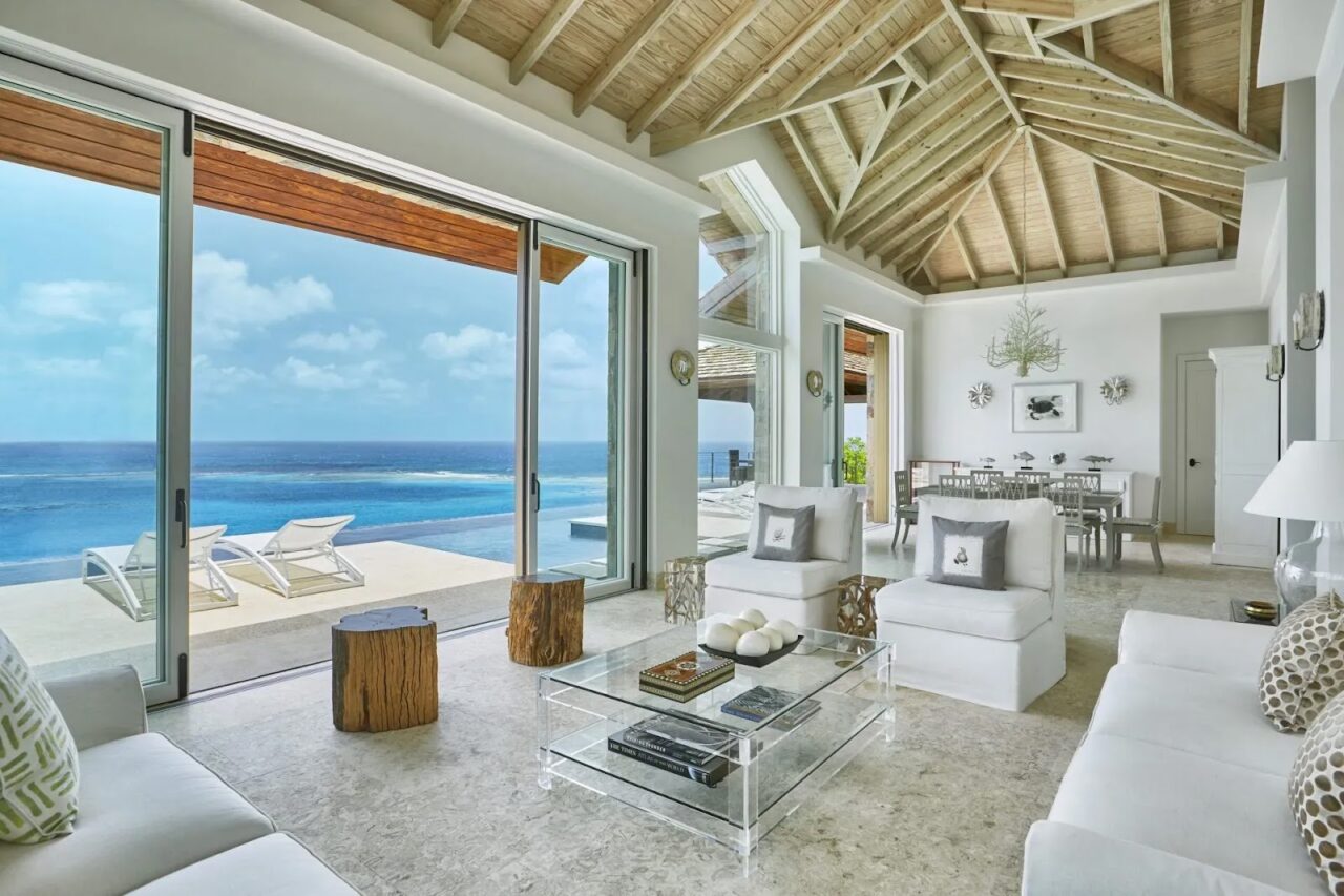 Bright Great Room at Reef House Villa featuring vaulted ceilings and floor-to-ceiling Caribbean views.