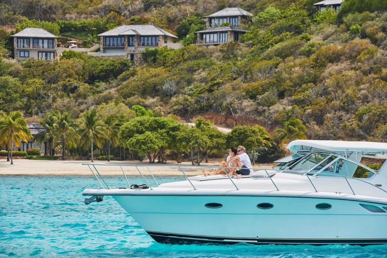 Couple relaxing on the deck of a private yacht charter off the coast of Virgin Gorda.